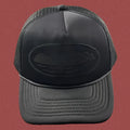 Cortiez All-Black Monochromatic Oval Ship Logo Trucker Hat
